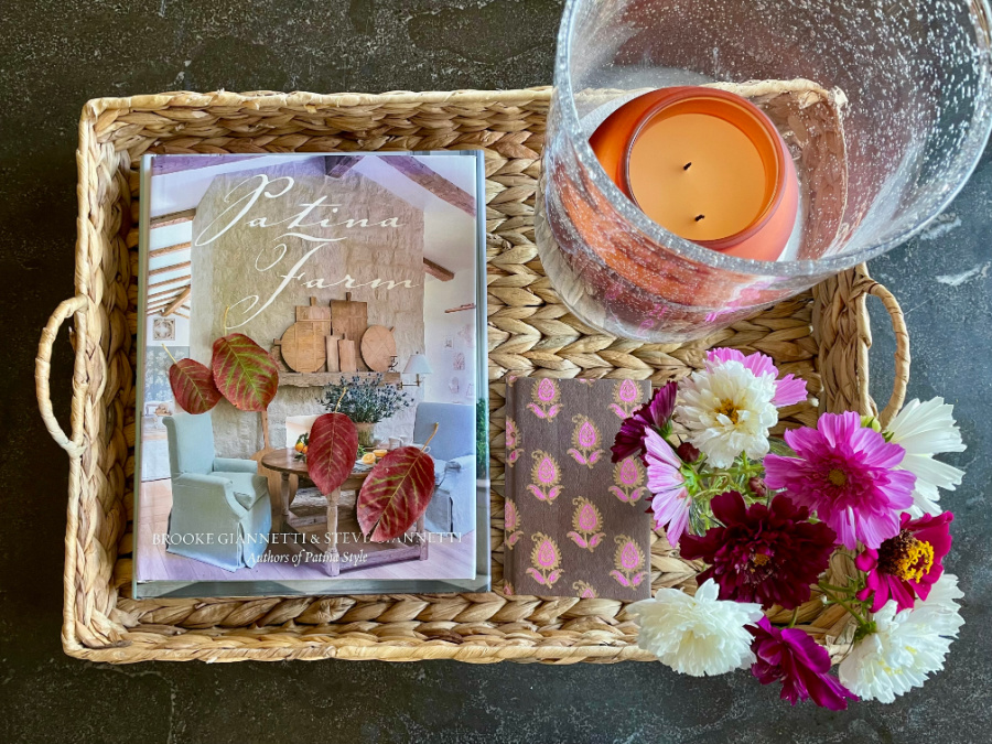 early fall flatlay with candle, flowers, leaves on tray