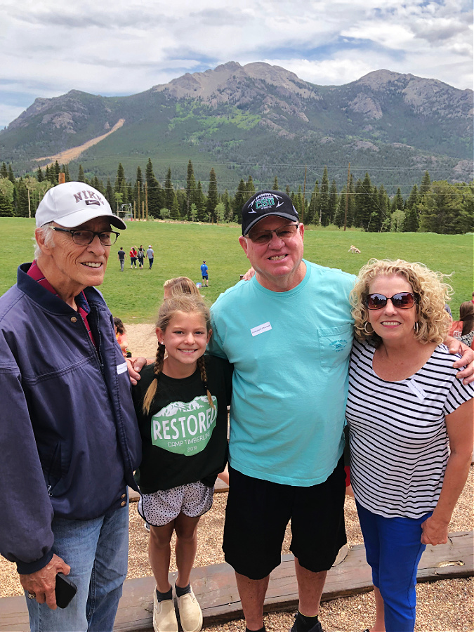 Grace with granddad, pap and memaw at camp T