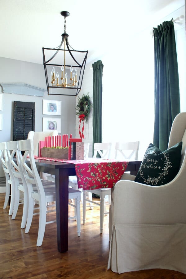 Our dining room is jazzed up for Christmas with pops of red and new velvet green curtains.