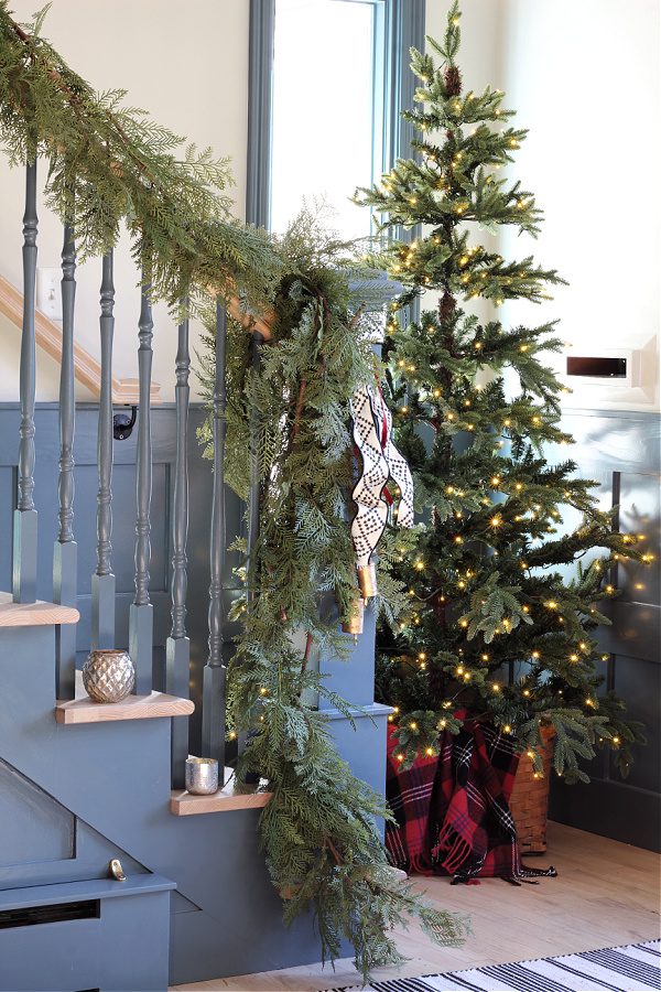 Garland and a tree at the base of our stairs.