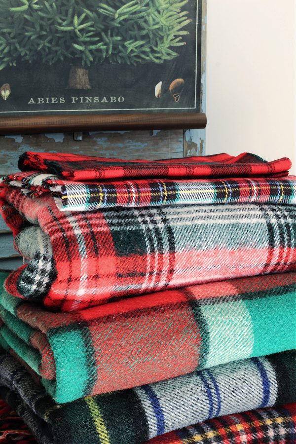 A fun stack of vintage plaid blankets for Christmas.