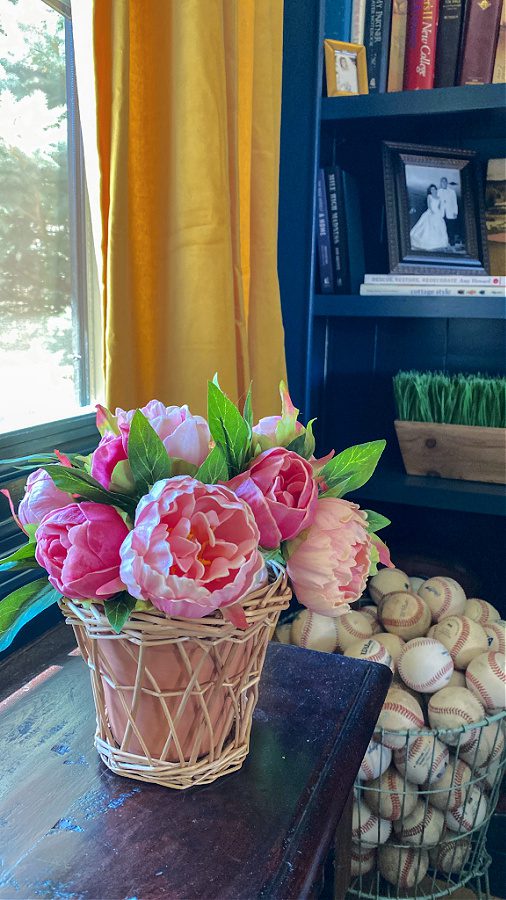 Pink peonies and baseballs in the office.