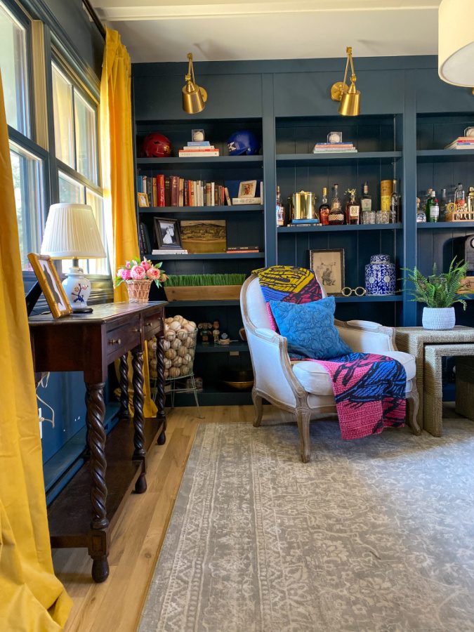 The blue office with yellow curtains and sport memorabilia. 