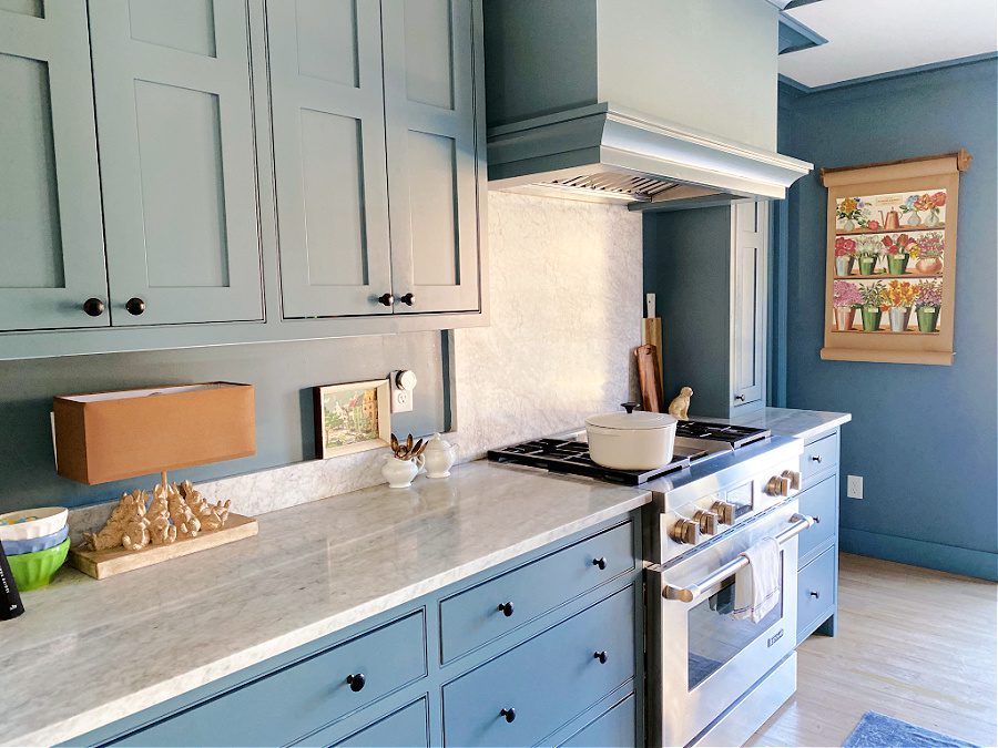 Blue kitchen with marble counters decorated for Spring.