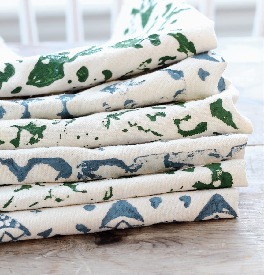 A stack of drop cloth napkins with DIY block print patterns