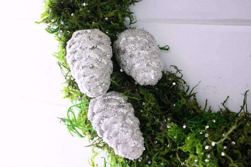 Add glitter or glittery pinecones to add that special touch to your Christmas moss wreath!