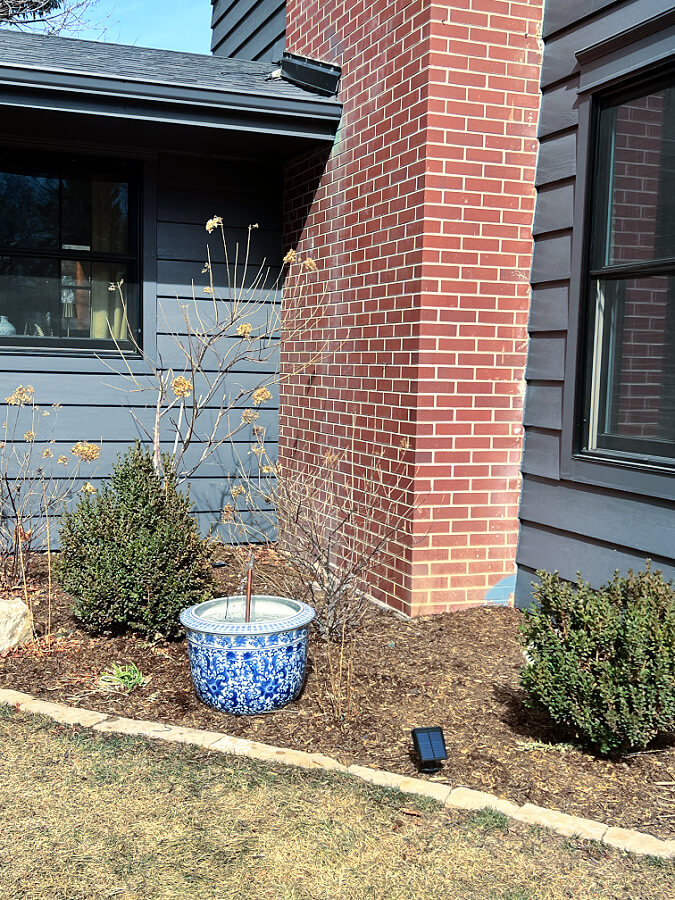 fountain in side flower bed