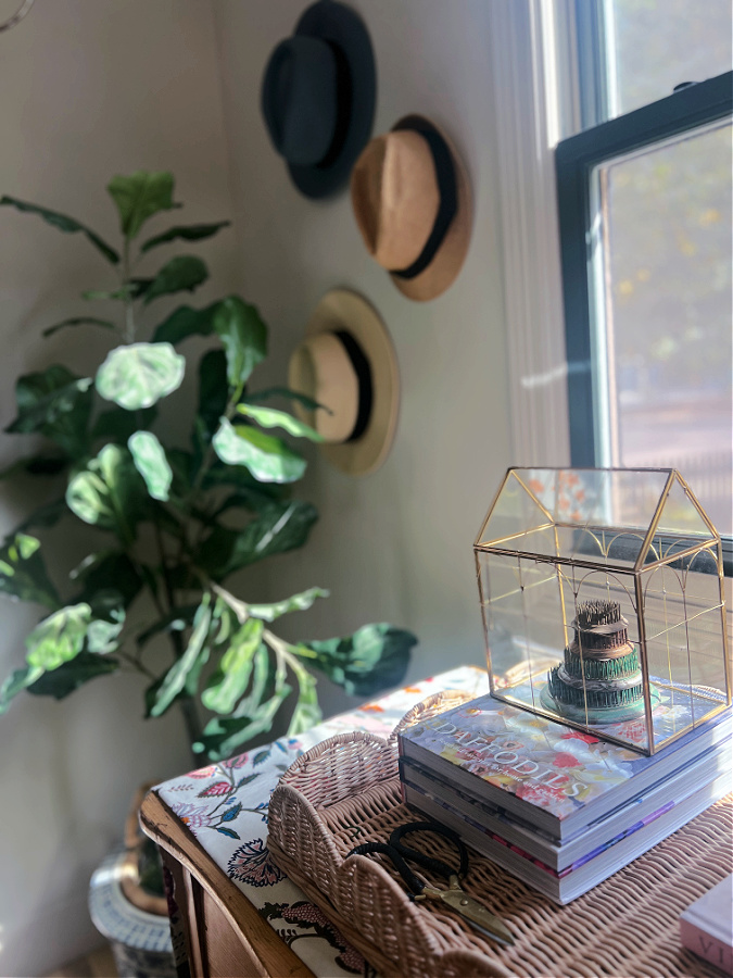fake fiddle in corner hats on wall