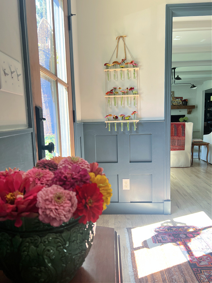 across the entry hanging flower vase with zinnias