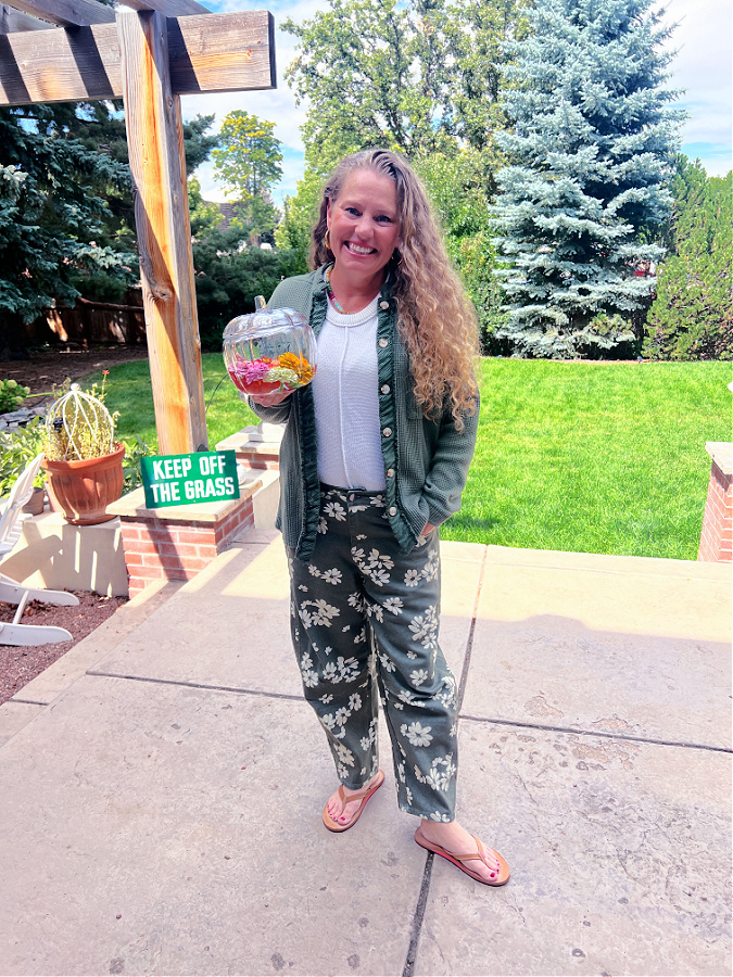Kelly in backyard holding glass pumpkin