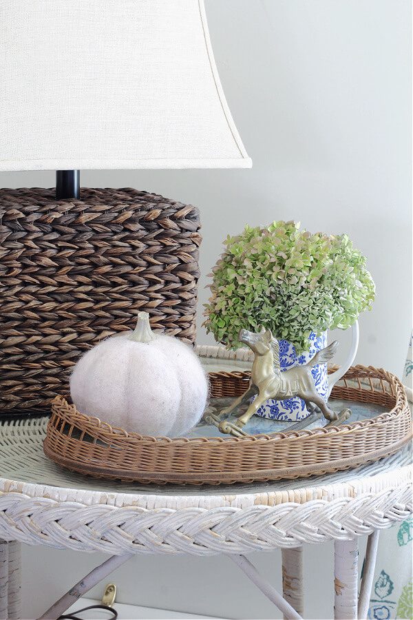 A Fall vignette with hydrangeas, pumpkins and brass.