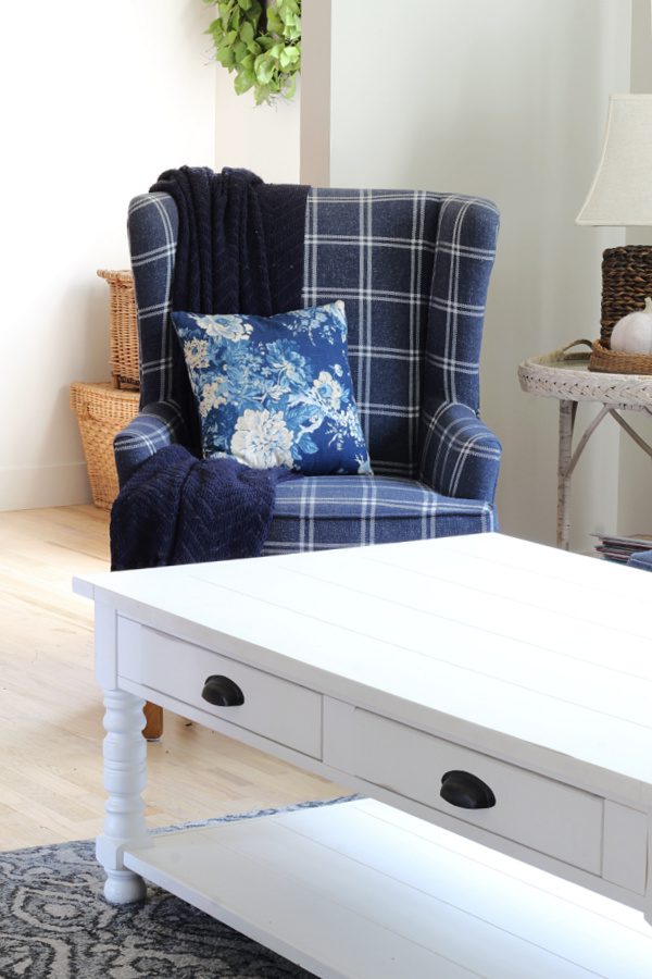 blue and white plaid chair with floral pillow