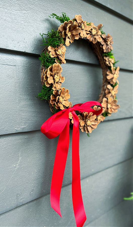 Pinecone flower wreath with red ribbon