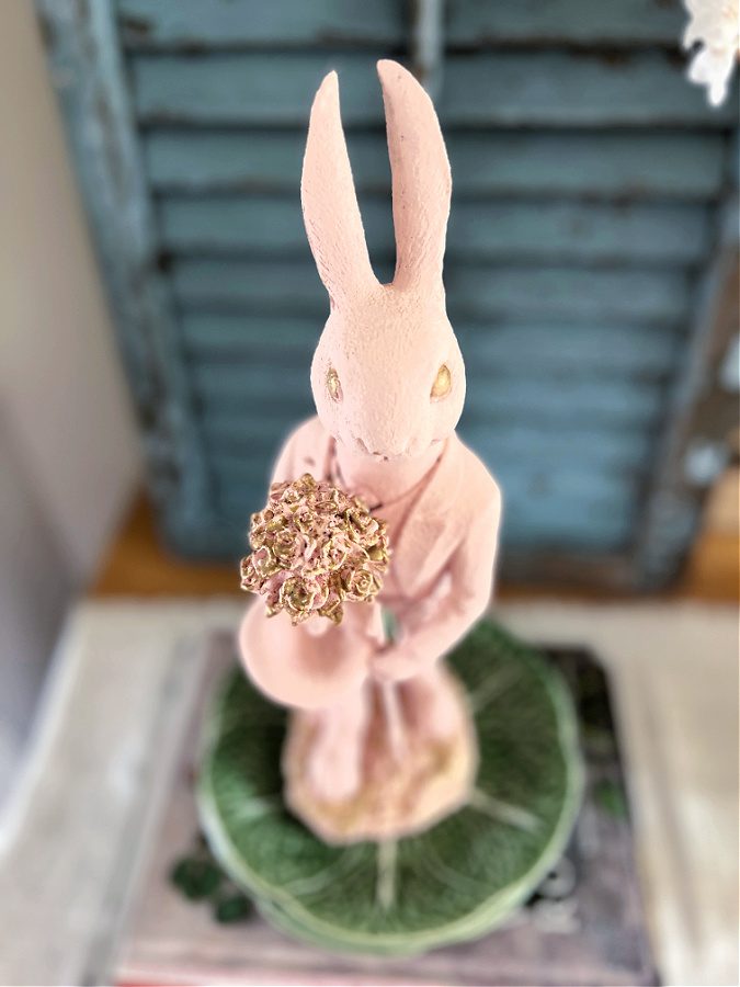 touches of gold paint on flowers Easter bunny is holding