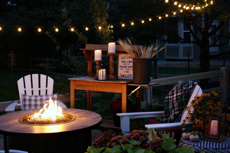 Fall outdoor decor featuring lights and lanterns.