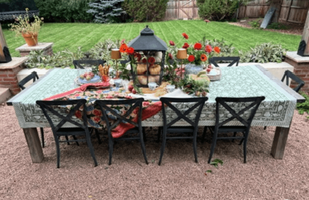 Fall outdoor table with fruit and flowers