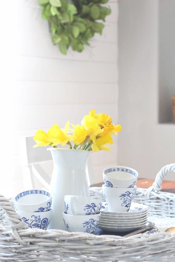 a pretty vignette of daffodils and blue and white ironstone.