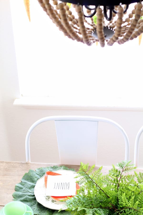 The bright pops of color make this simple Easter table featuring Rae Dunn and jadeite a fun table setting.