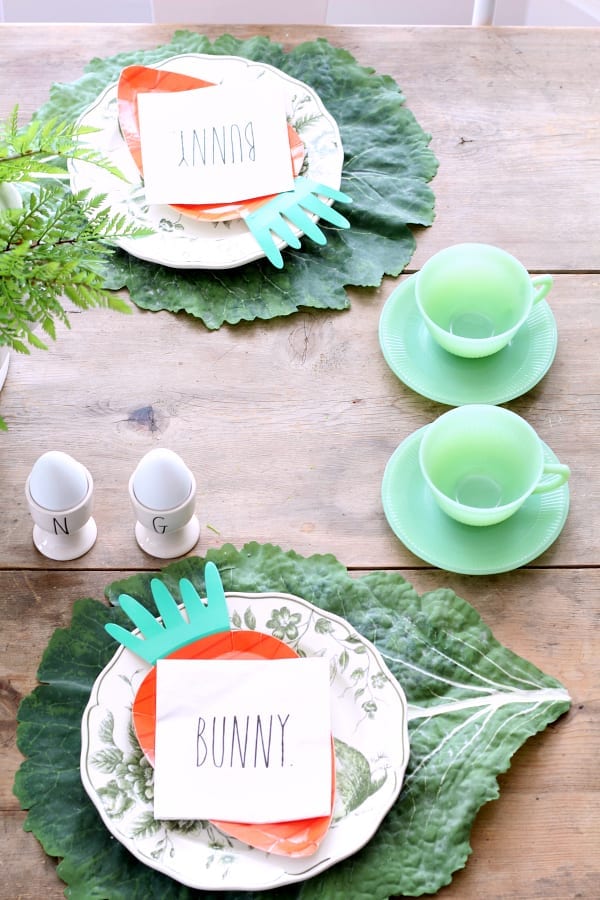 Vintage jadeite cups and saucers pair well with these carrot paper plates and Rae Dunn bunny napkins.