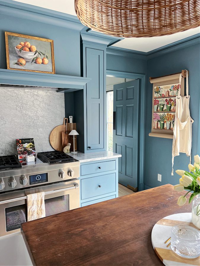 View of kitchen with blue cabinets