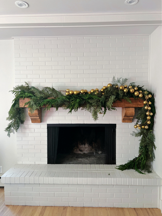 adding an ornament garland to our Christmas mantel