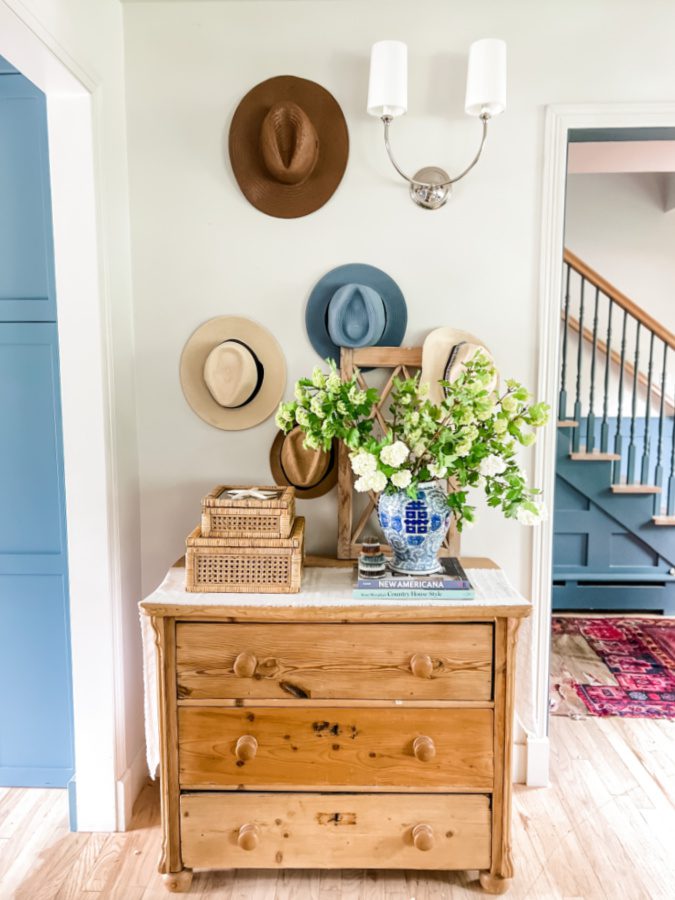 a hat wall above our pine dresser with viburnum snowballs on it.