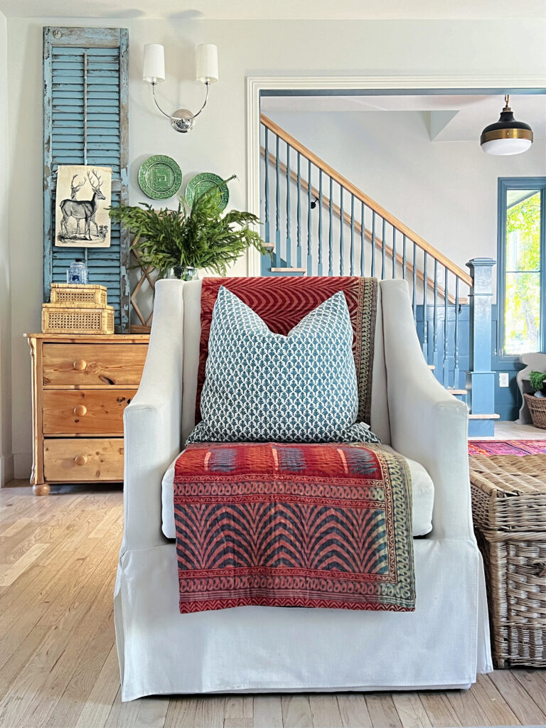 chair with colorful pillow and throw for decluttering space in Winter