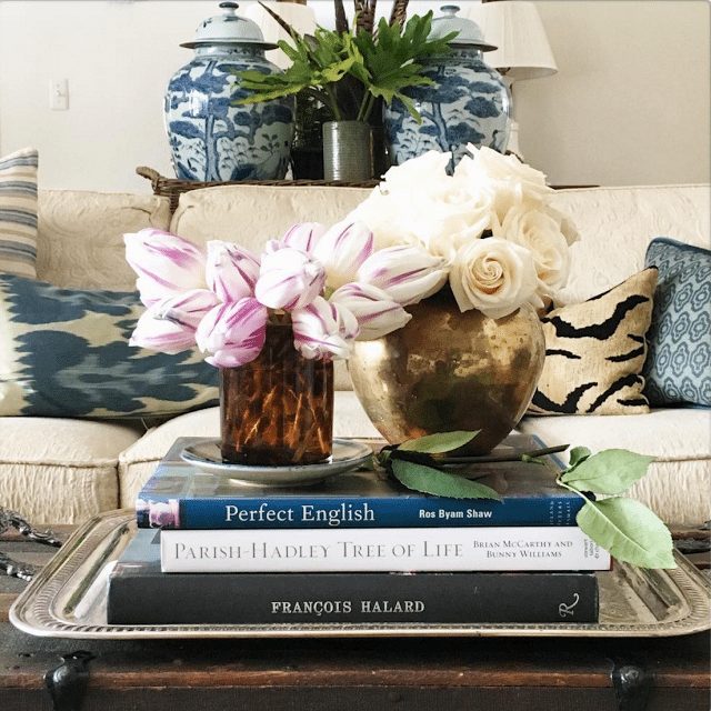 tortoise shell vase with flowers on books