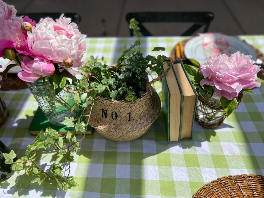 Ivy and peonies and books on a gingham tablecloth