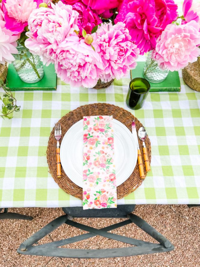 Pretty place settings for an outdoor table using pinks and greens.