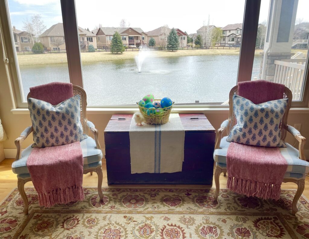 two chairs with pond in background