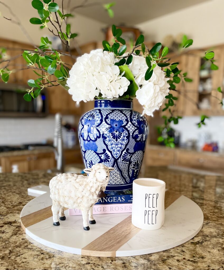 white hydrangeas in blue and white vase, peep peep mug and lamb figurine