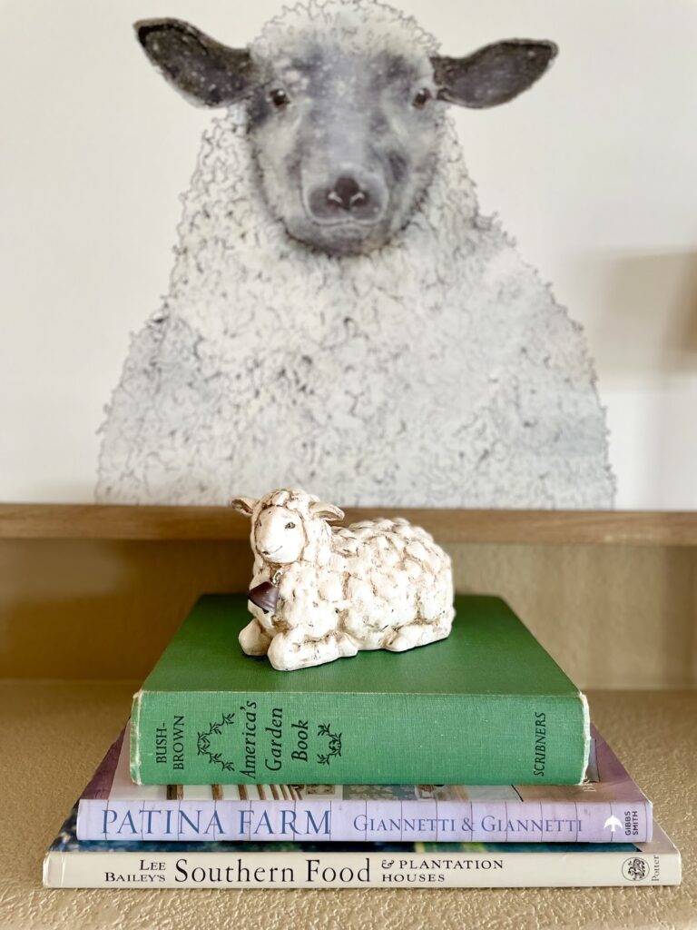 lamb figurine on book stack