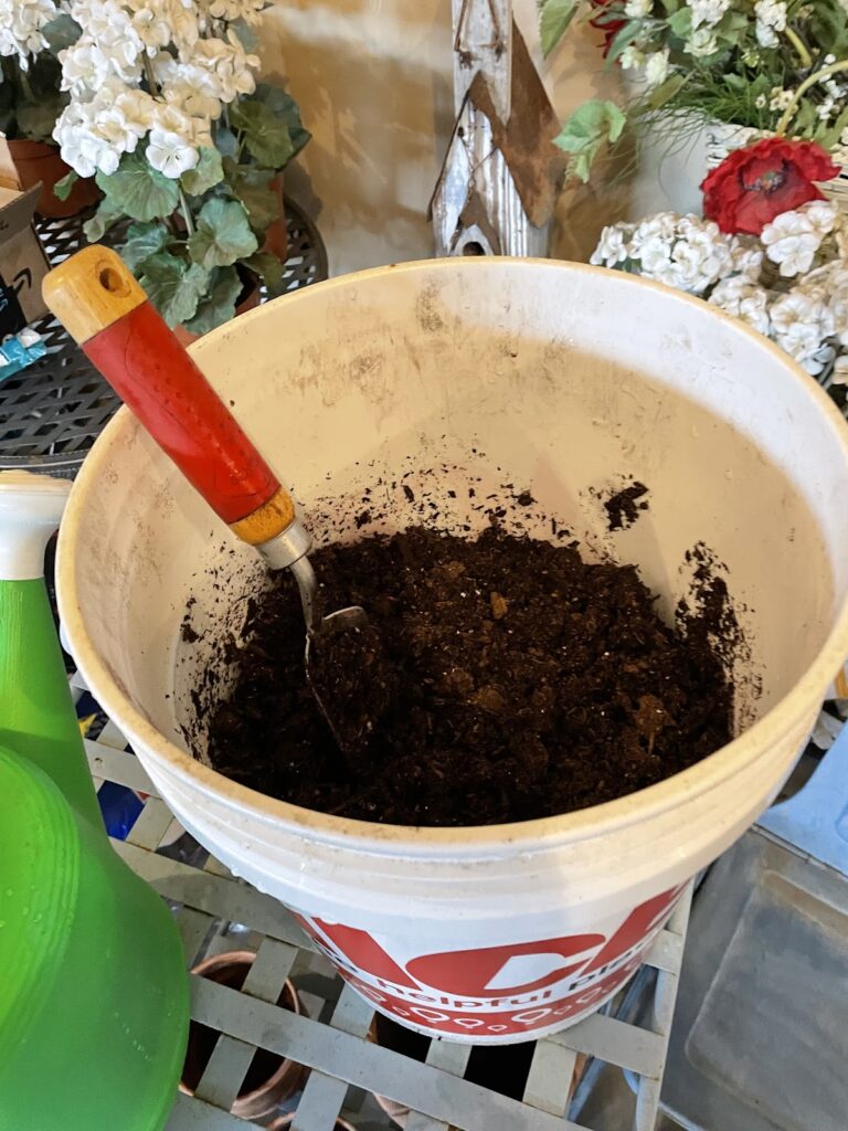 soil in bucket with shovel