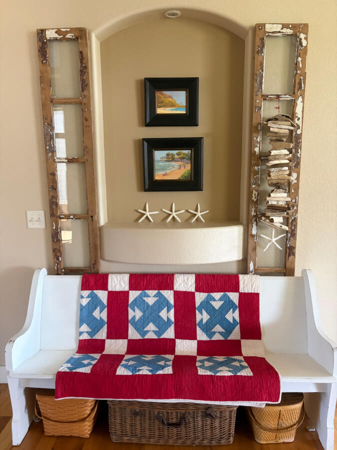 pew with bleu and white quilt