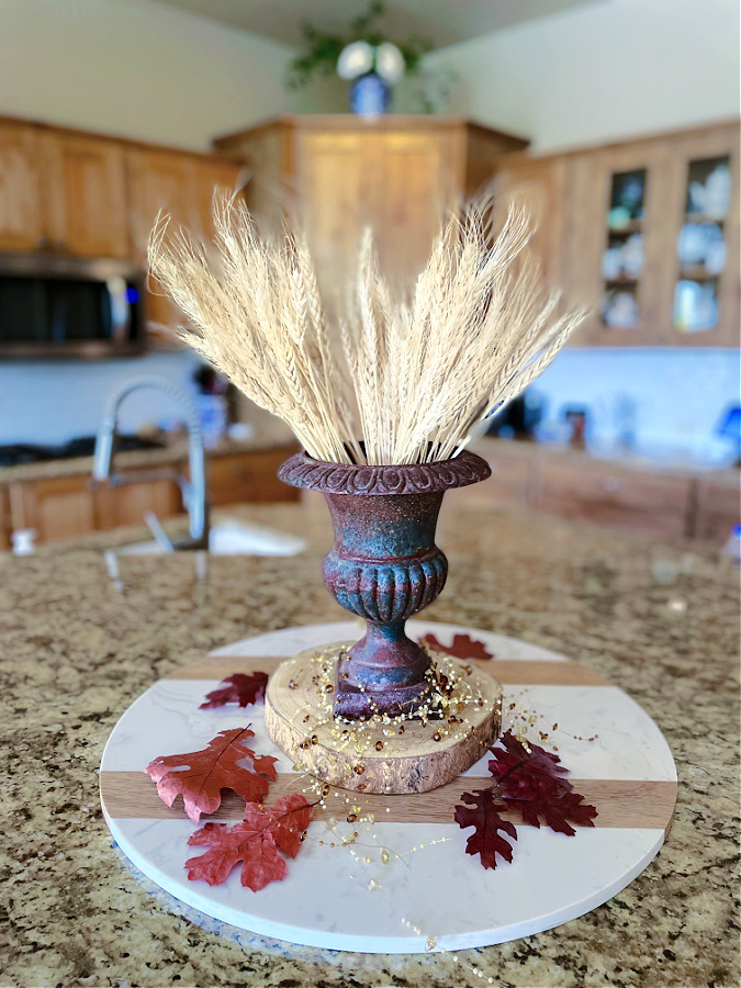 wheat in old urn on counter in kitchen