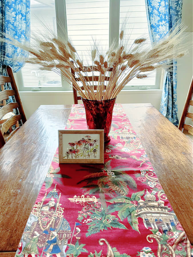 mini framed flower picture and wheat on table