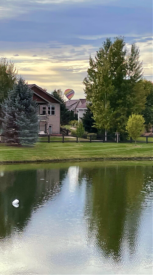 hot air balloon over pond 