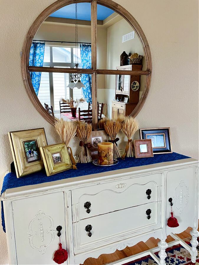 wheat and picture frames on side table