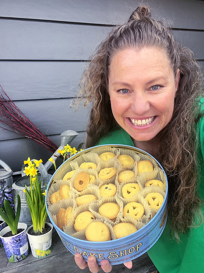 me holding a tin of cookies