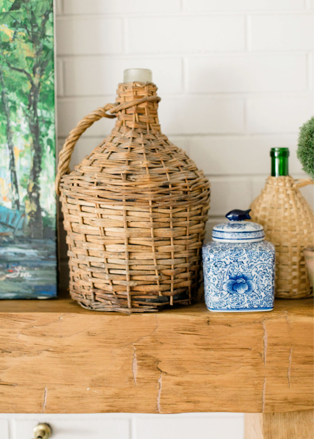 vintage wicker demijohn on mantel