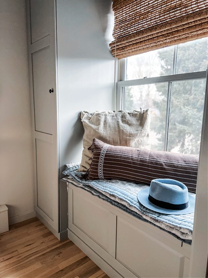 pillows and a hat on the window seat make a cozy spot.