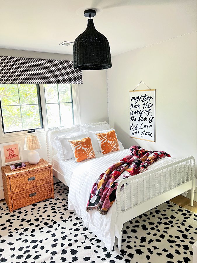 Beachy Teen bedroom with large black chandelier and white bed