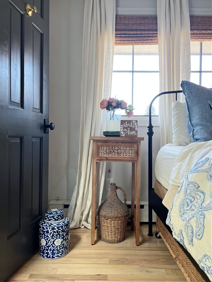 Our bedside table with faux pink flowers and coastal accents.