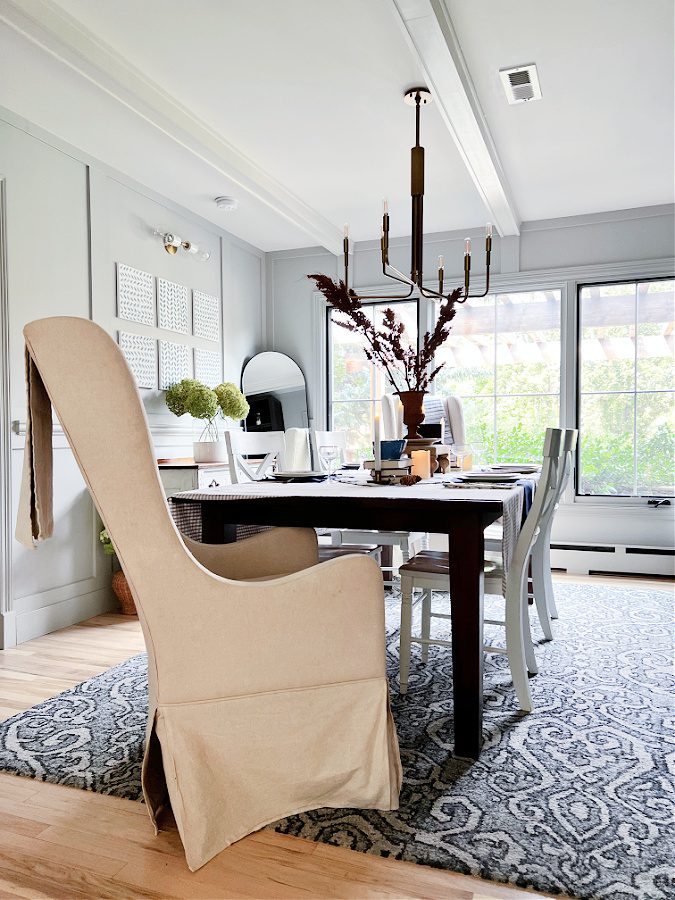 Captains chair in dining room with table set for Fall