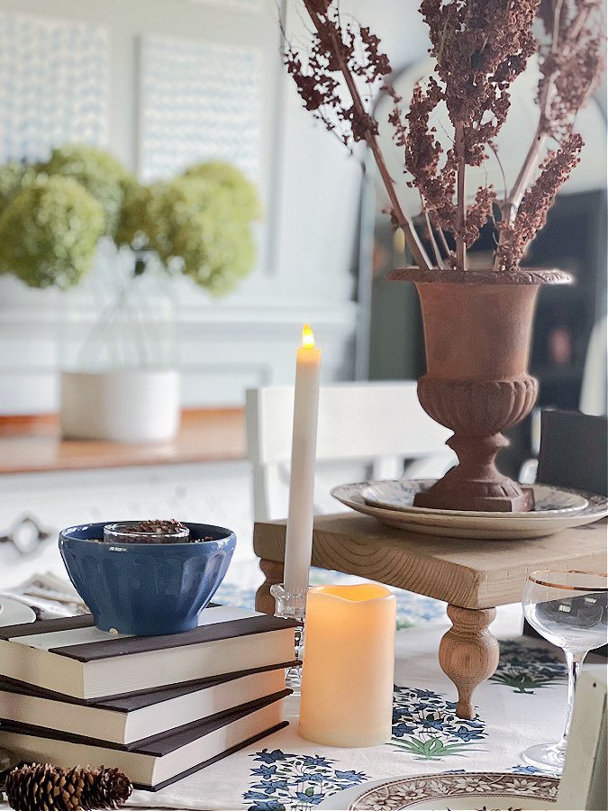Candles and books on mismatched Fall tablescape plus more ideas