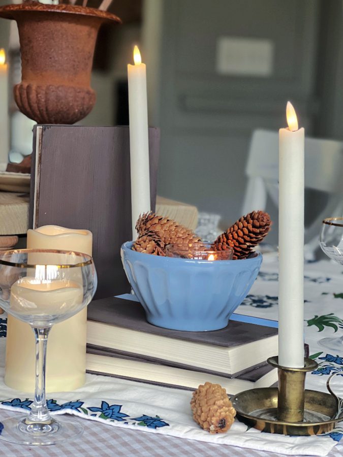 pinceones in bowl, candles on table