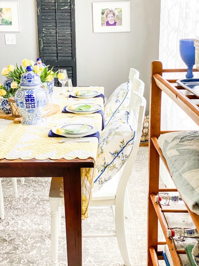 A vintage quilt add the perfect pop of yellow to this Mother's Day table.