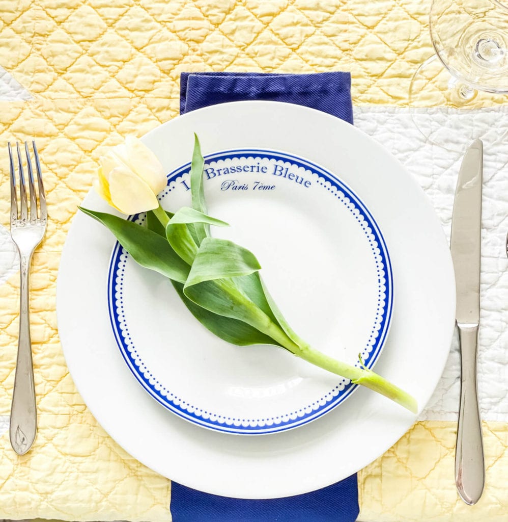 These blue and white plates look pretty with a single tulip added for a fun pop of color!