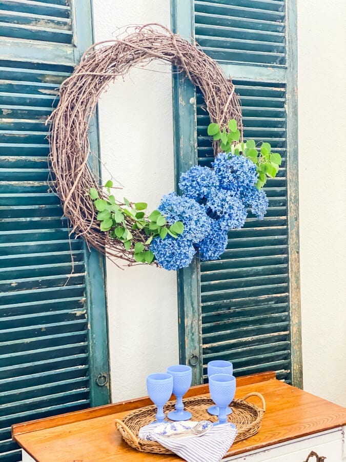 The perfect summer wreath includes blue spray painted hydrangeas!